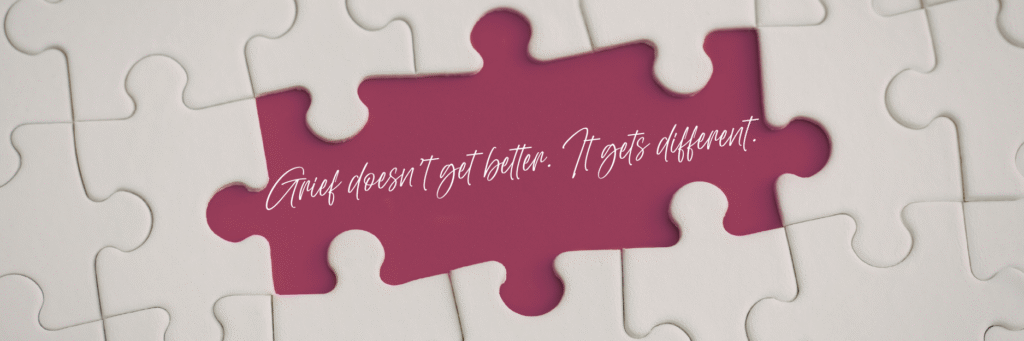 White puzzle with one missing piece revealing a maroon background with the quote “Grief doesn’t get better. It gets different,” symbolizing loss and healing.